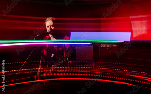 Vivid Light Trails Enhance a Live Rock Music Performance photo