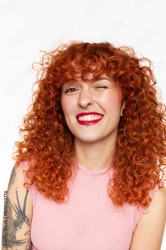 Redhead woman winking in white studio Redhead woman winking in white studio