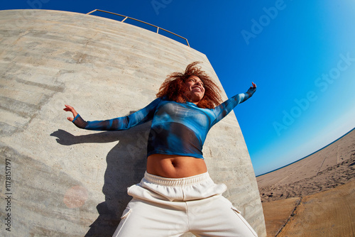 Happy woman jumping with stretched arms photo