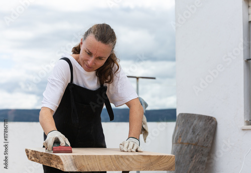 A woman making a piece of furniture by hand photo