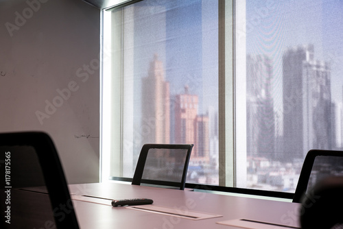 An empty corporate meeting room with the Bangkok cityscape behind it photo