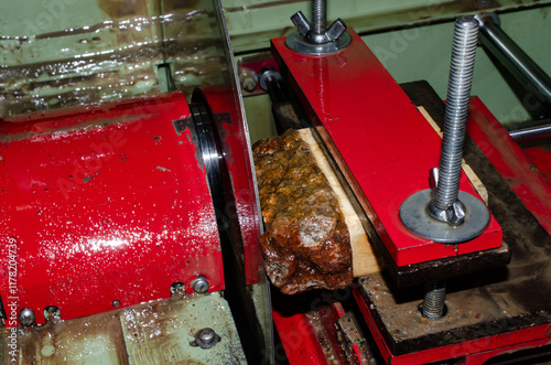 Lapidary rock saw used to cut raw gemstone, stone and rock into slabs. Machinery used for hobby of cutting stone. Lap workshop for cutting, shaping and polishing gemstone and rock to create jewelry an