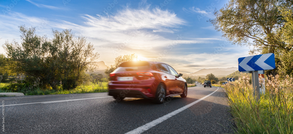 Fototapeta premium rental car in spain mountain landscape road at sunset