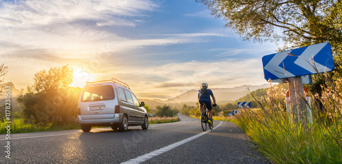 rental car in spain mountain landscape road at sunset overtake a bicycle photo