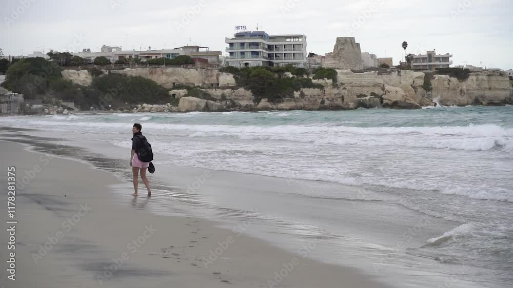 Storm. A woman walks along a picturesque beach. Storm. A woman walks along a picturesque beach.