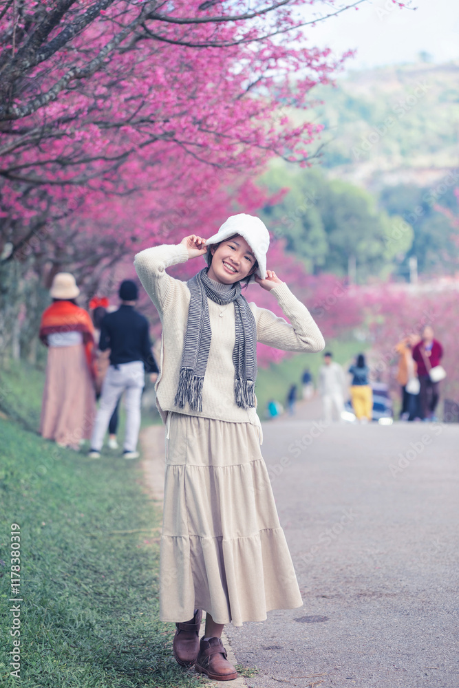 Happy travel Asian teen girl smile with sakura cherry blossoms tree on vacation while spring park nature background. , Journey trip lifestyle Happy travel Asian teen girl smile with sakura cherry blossoms tree on vacation while spring park nature background. , Journey trip lifestyle