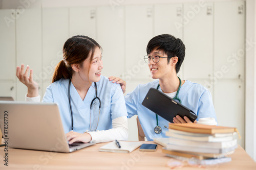 Smart Asian female and male medical students are working together on medical research homework.