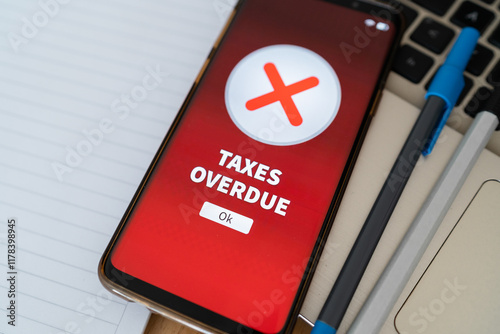 Taxes overdue notification on smartphone. Concept of problems paying taxes on time.
