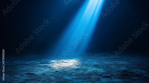 Underwater scene with a single beam of light illuminating the ocean floor. photo