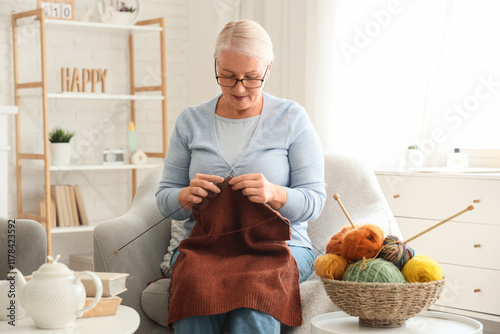 Mature woman knitting sweat...