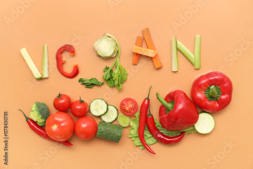 Composition with word VEGAN and different fresh vegetables on color background