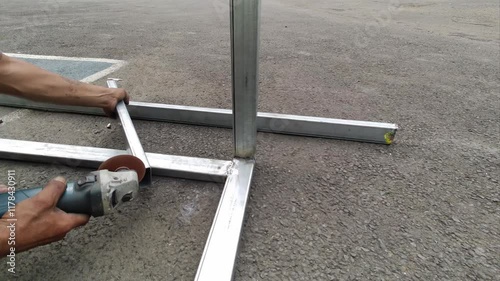 Focus hand worker or male welder using grinding machine after welding aluminum. Grinding machine is used to clean and smooth the weld joint.