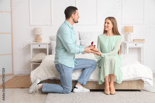Young man proposing to his ...