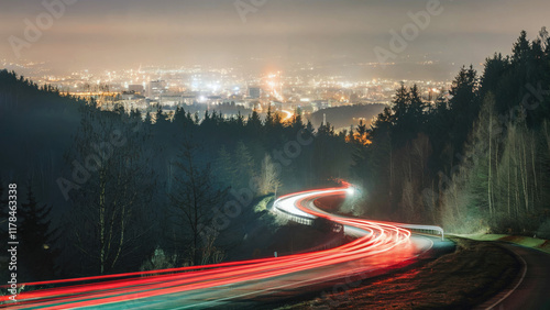 long exposure Car headlights taillights break lights  light trail blur winding around a curvy mountain road in the mountains