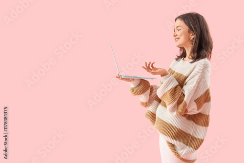 Young woman with laptop vid...