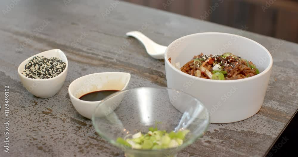 Delicious Asian noodle dish garnished with sesame seeds and green onions Delicious Asian noodle dish garnished with sesame seeds and green onions
