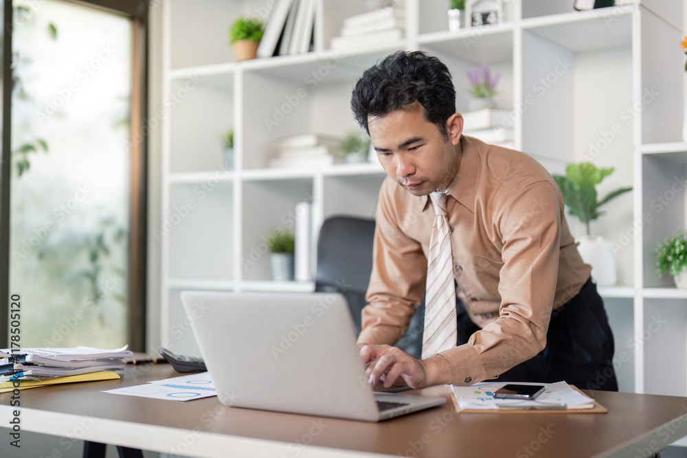 Focused business professional working on laptop in modern office environment productivity technology contemporary workspace Focused business professional working on laptop in modern office environment productivity technology contemporary workspace