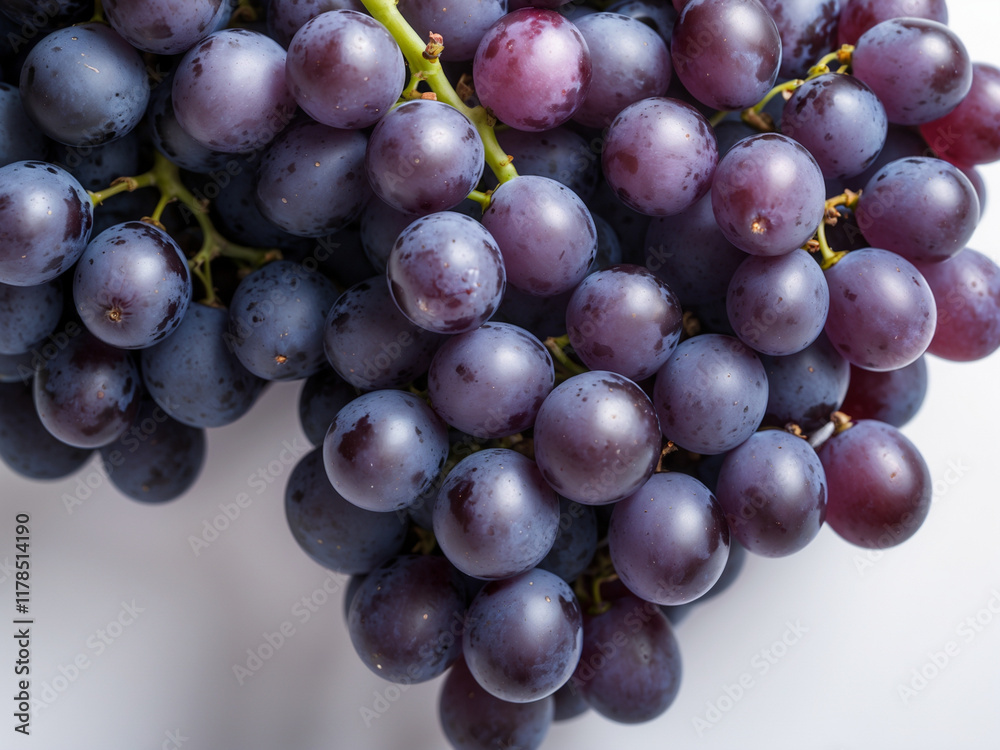 Fototapeta premium a fresh bunch of purple and blue grapes with a glossy surface on a white background. Ideal for themes of healthy eating, organic produce, and natural food photography.