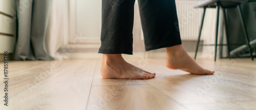 Barefoot walking on warm wooden flooring provides comfort and relaxation in a cozy interior space during a peaceful day