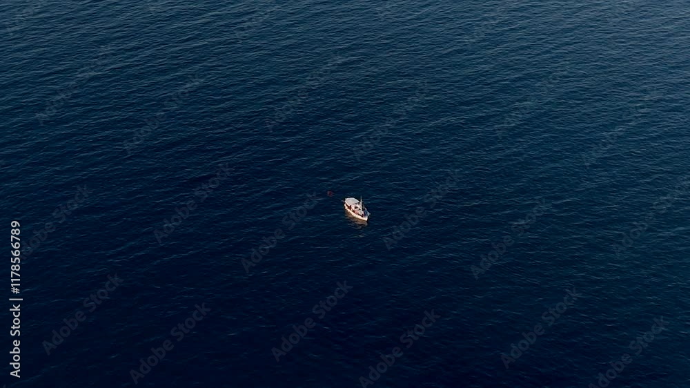Aerial - fishing boat on deep blue sea near Crete, Greece Aerial - fishing boat on deep blue sea near Crete, Greece
