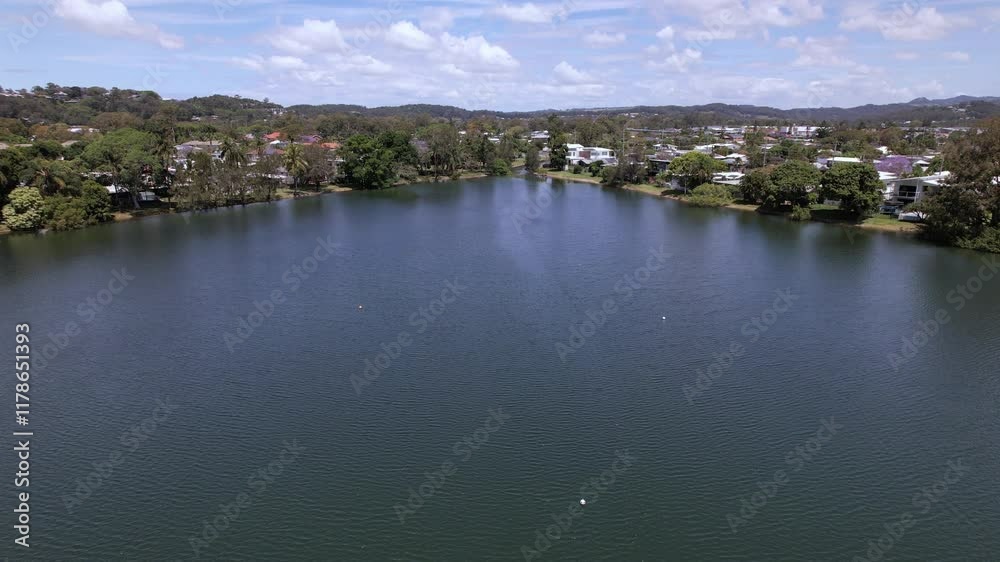 Cavemans Lake Surrounded By Vegetation And Houses In Queensland, Australia. ascending drone shot Cavemans Lake Surrounded By Vegetation And Houses In Queensland, Australia. ascending drone shot