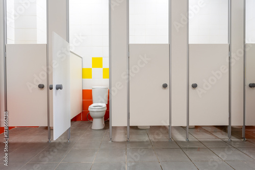 Φωτογραφία Clean public restroom with separate stalls and colorful wall design in a modern