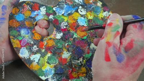 Wallpaper Mural The hands of the artist, work to create creative images in art. Art paints and brushes, applying multi-coloured strokes to the canvas using palette, gouache and watercolour. Torontodigital.ca