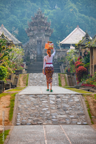 Balinese women carrying on religious offering - Penglipuran is a traditional oldest Bali village at Bangli Regency - Bali, Indonesia photo