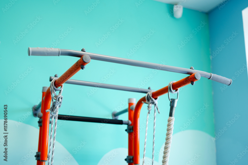 Home gym setup with colorful pull-up bar on bright blue wall for fitness enthusiasts Home gym setup with colorful pull-up bar on bright blue wall for fitness enthusiasts