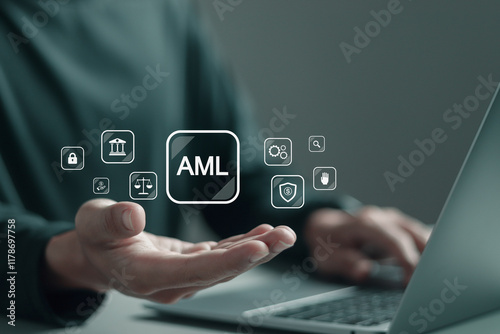 AML, Anti money laundering financial bank concept. Person using laptop with AML icons on virtual screen for anti money laundering regulations.