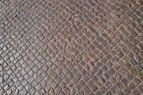 Stone road pattern background. Cobblestone pavement background. Textured background of cobblestone road. Brick road background. photo