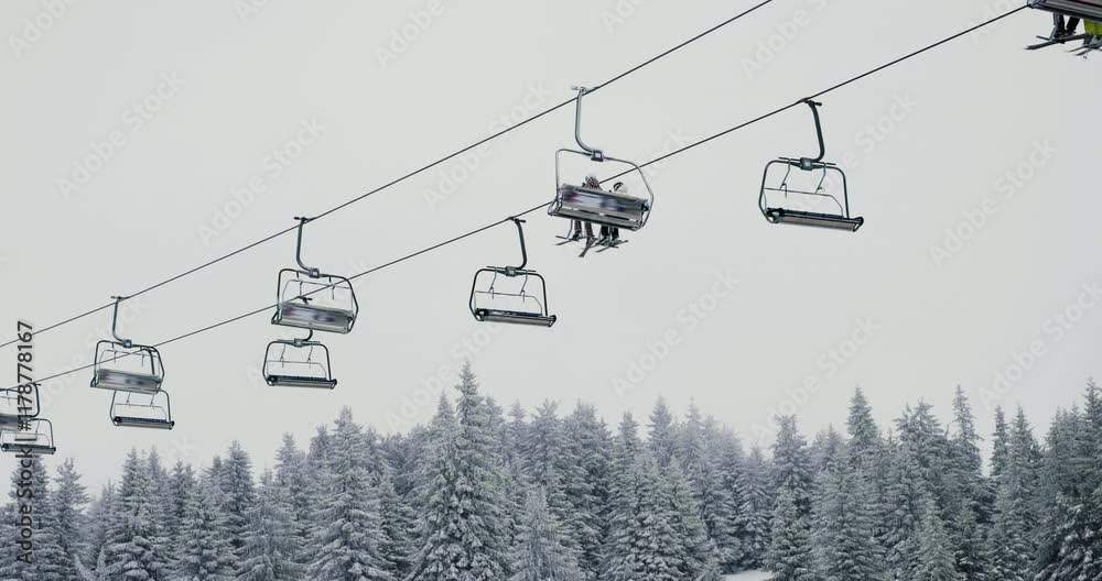 Scenic winter landscape with chairlift above snow-covered forest during snowfall in Kopaonik, capturing serene mountain beauty and outdoor adventure on a calm, snowy day Scenic winter landscape with chairlift above snow-covered forest during snowfall in Kopaonik, capturing serene mountain beauty and outdoor adventure on a calm, snowy day