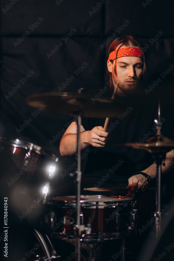 Drummer rehearsing on drums before rock concert. Man recording music on drum set in studio Drummer rehearsing on drums before rock concert. Man recording music on drum set in studio