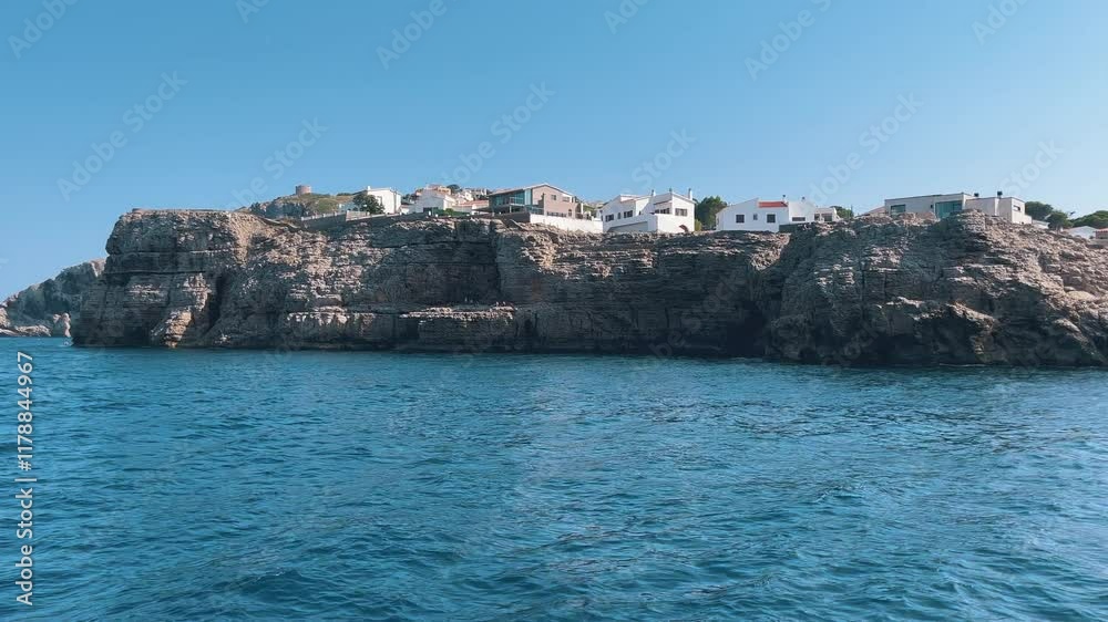 View from the water of big beautiful vacation homes on the coast of the Mediterranean Sea. View from the water of big beautiful vacation homes on the coast of the Mediterranean Sea.