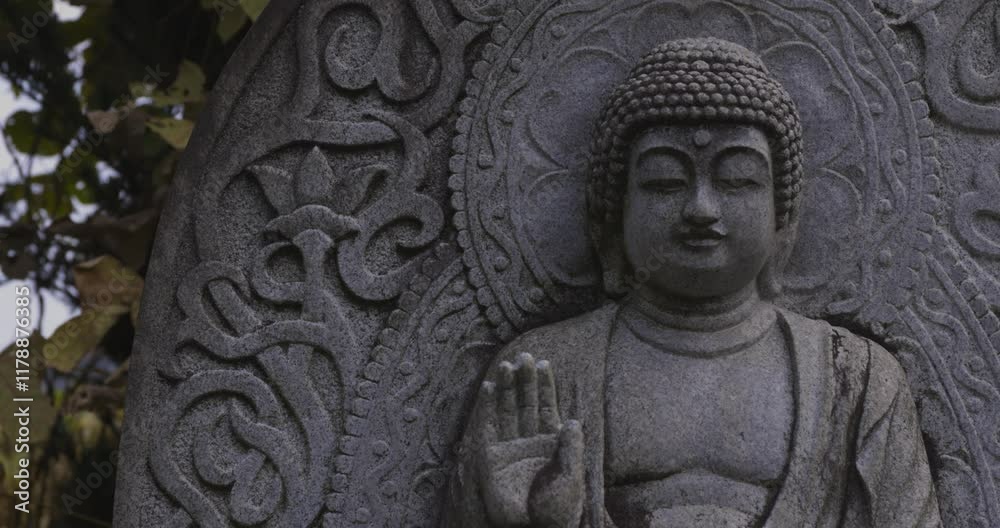 A religious stone statue of Shaka Nyorai at Japanese buddhism temple A religious stone statue of Shaka Nyorai at Japanese buddhism temple