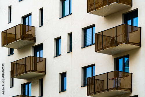 Modern Residential Apartment Building with Minimalist Design, Metal Balconies, and Large Windows