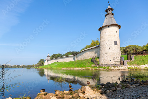 Ancient walls and towers of the medieval Pskov kremlin on the Velikaya river in summer photo