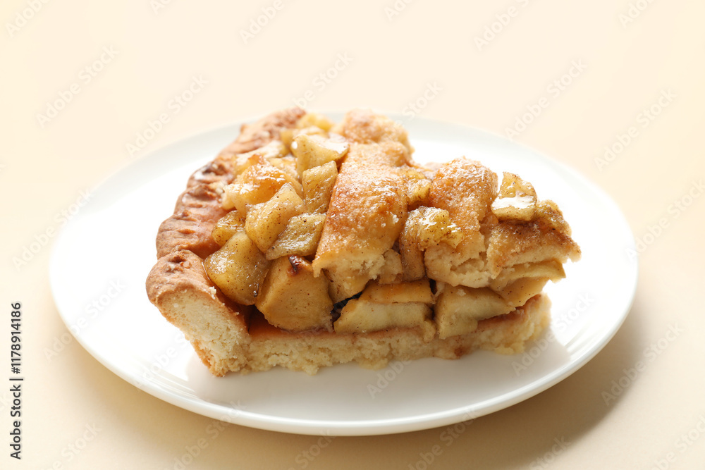 Slice of homemade apple pie on beige background, closeup Slice of homemade apple pie on beige background, closeup