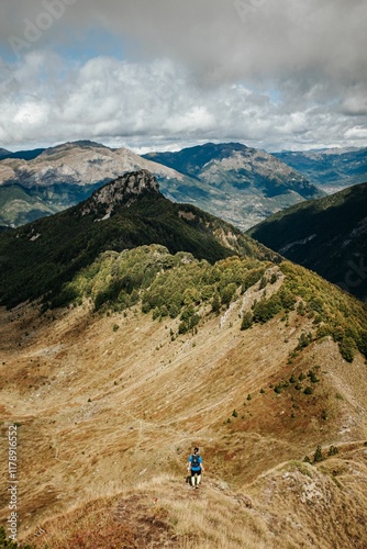 Hiker in the Apennines with scenic mountain view.