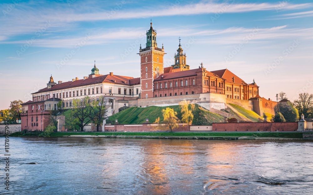 Naklejka premium Krakow's Wawel Castle, Poland Majestic Wawel Castle at sunset, overlooking the Vistula River.