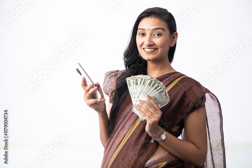Female Posing In Front Of Camera With Indian Currency Notes And Mobile Phone In Hand