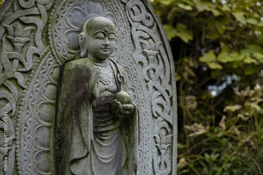 A religious stone statue of Jizo at Japanese buddhism temple A religious stone statue of Jizo at Japanese buddhism temple
