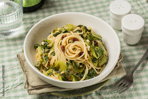 Pasta with scarola or escarola, raisins, pinolli, anchovies and capers. photo