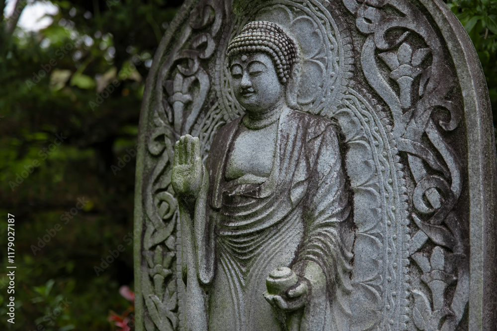A religious stone statue of Medicine Buddha at Japanese buddhism temple A religious stone statue of Medicine Buddha at Japanese buddhism temple