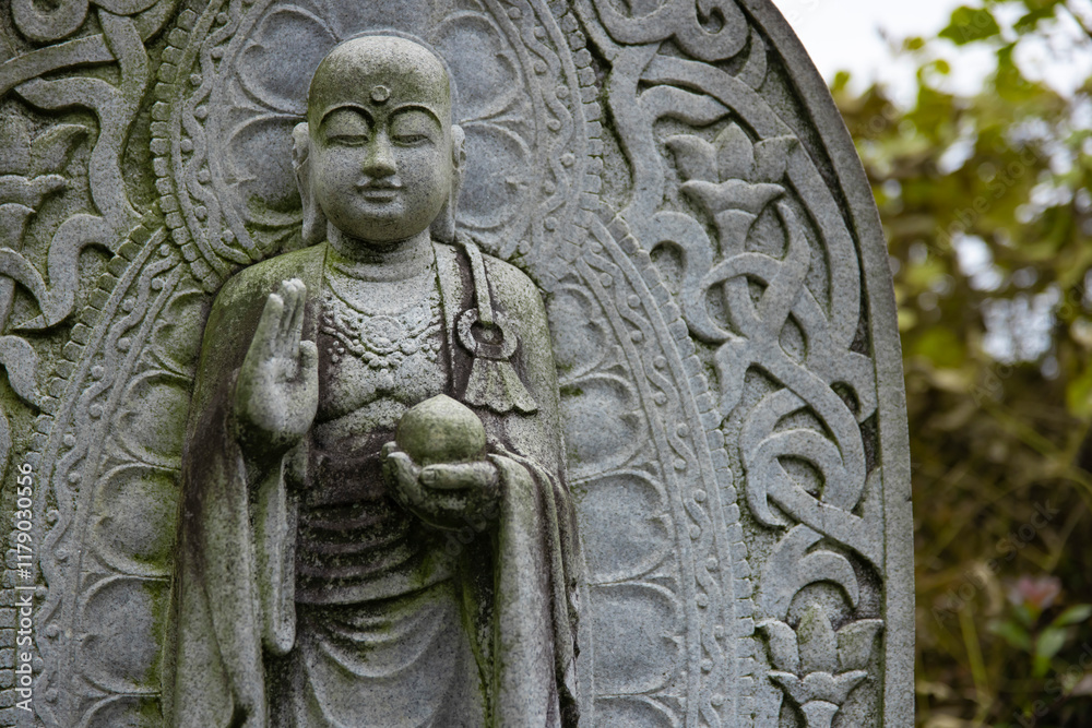 A religious stone statue of Jizo at Japanese buddhism temple A religious stone statue of Jizo at Japanese buddhism temple