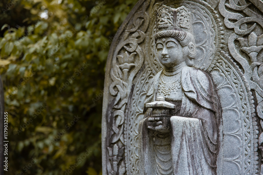 A religious stone statue of Maitreya at Japanese buddhism temple A religious stone statue of Maitreya at Japanese buddhism temple