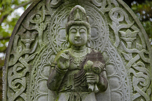 A religious stone statue of Mahasthamaprapta at Japanese buddhism temple photo