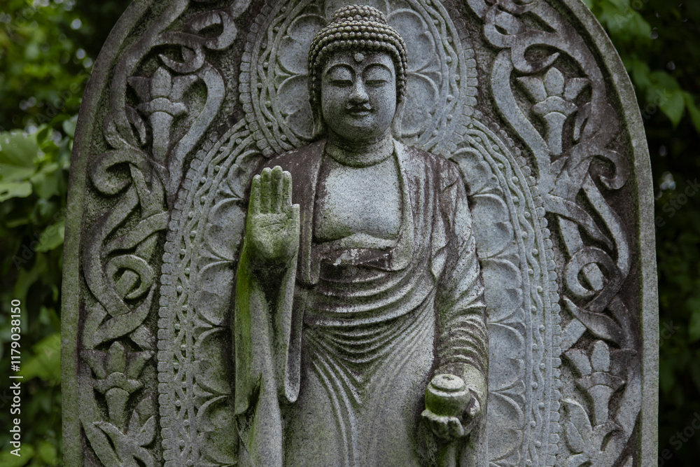 A religious stone statue of Medicine Buddha at Japanese buddhism temple A religious stone statue of Medicine Buddha at Japanese buddhism temple