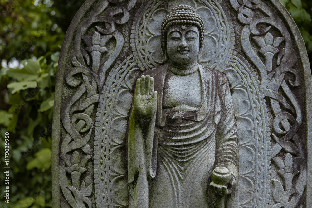 A religious stone statue of Medicine Buddha at Japanese buddhism temple A religious stone statue of Medicine Buddha at Japanese buddhism temple