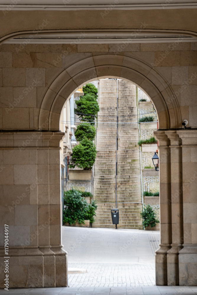 Beautiful Arch leading to staircase on main square Praza de Maria Pita in Coruna, Galicia, Spain